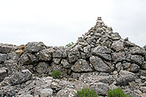 A cairn marks the first summit