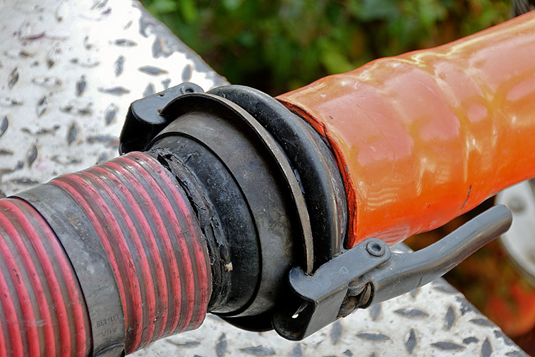 A hose is connected to the rear of the harvesting bin
