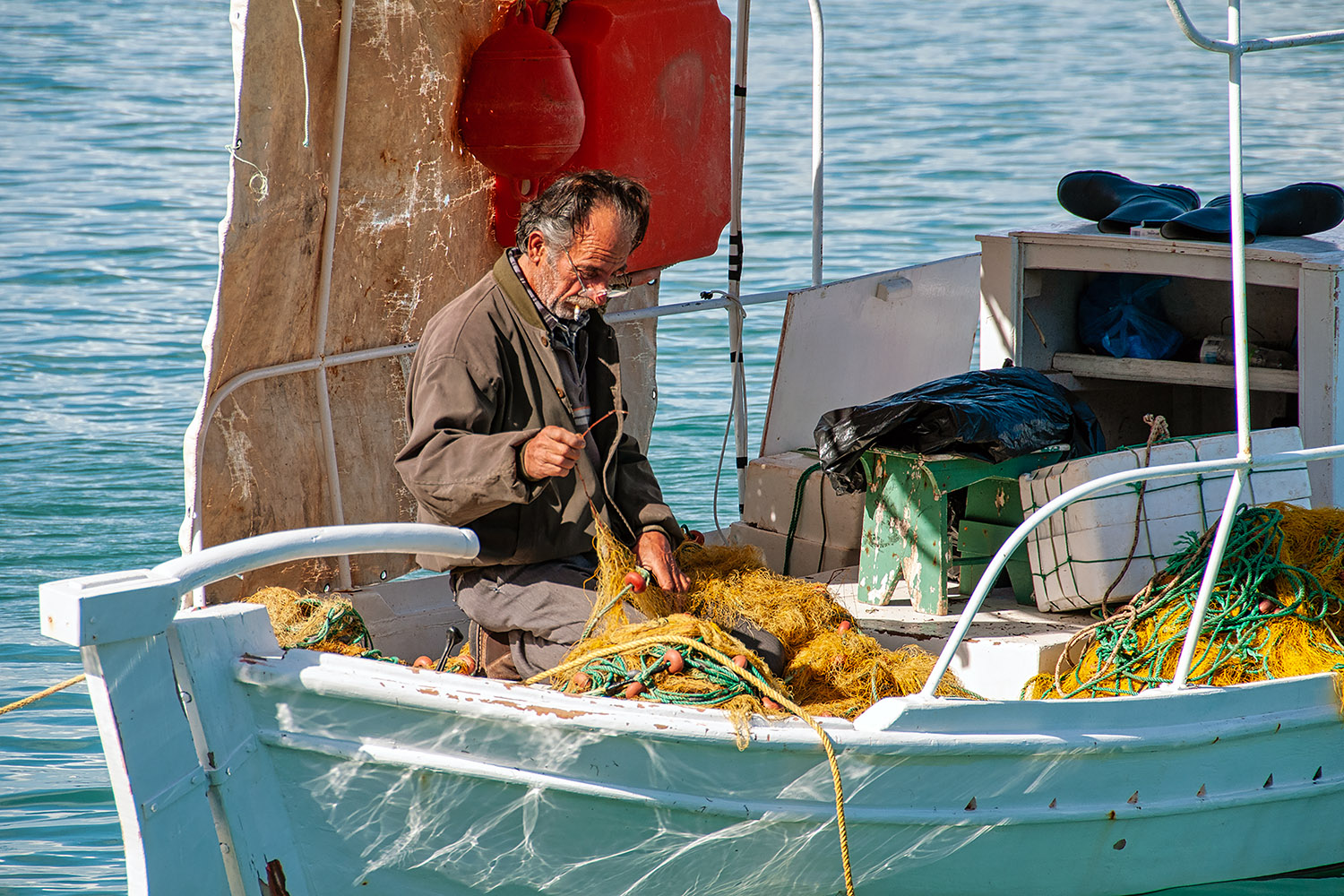 Fisherman mending his nets