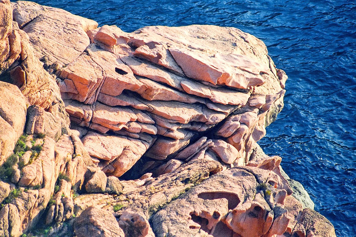 Reddish rocks and  blue sea