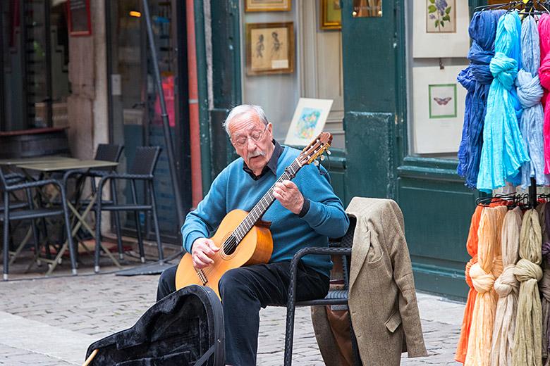 A street musician playing classical guitar