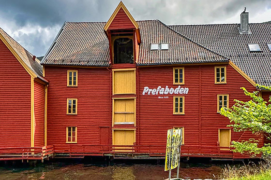 Colorful storage building supported by wooden piles