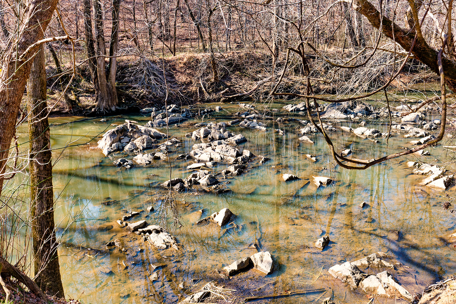 The water level is too low to cover the many rocks